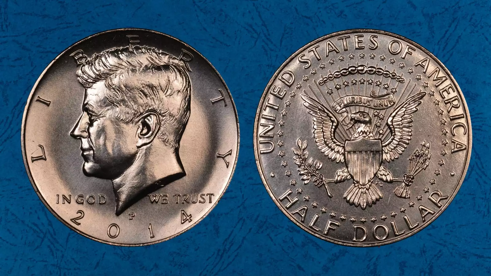 Grading strip showing four 2014 Kennedy half dollars in worn, about uncirculated, uncirculated, and gem condition